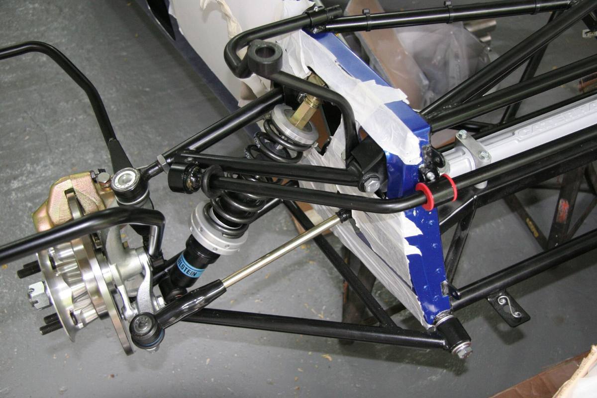 Pryžová pouzdra stabilizátoru v rukou mechanika při stavbě vozu Caterham